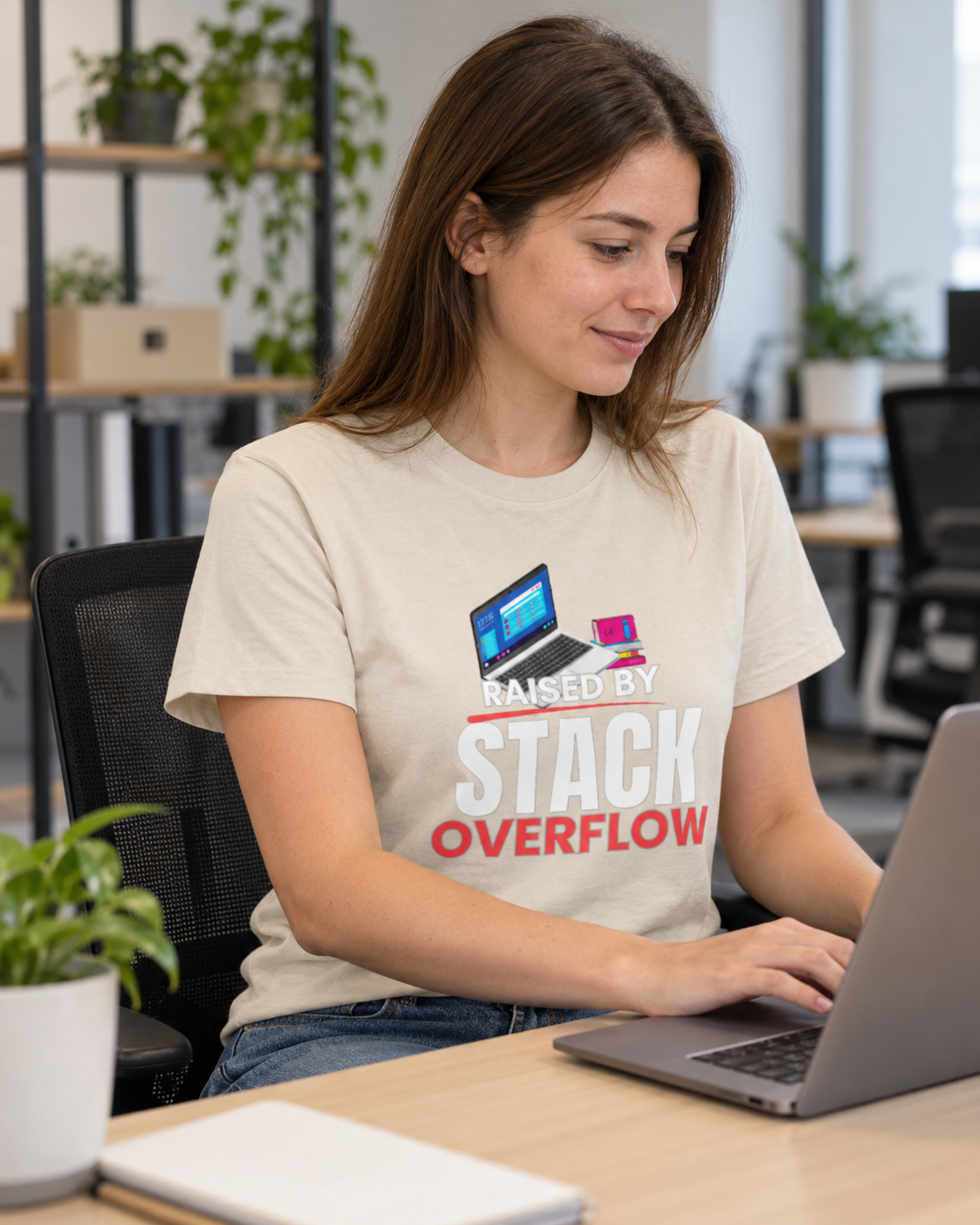 Woman at the office wearing a Raised by Stack Overflow programmer T-shirt